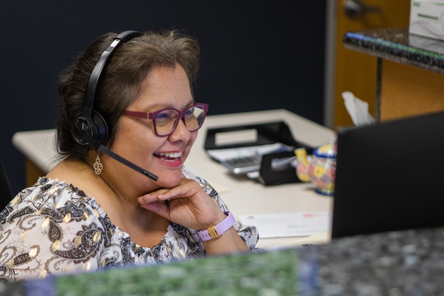 documation employee smiling as she talks on her headset